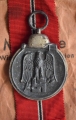 A 1941 - 42 EAST MEDAL marked 65 with paper bag maker Klein & Quenzer, Idar-Oberstein.