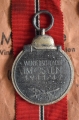 A 1941 - 42 EAST MEDAL marked 65 with paper bag maker Klein & Quenzer, Idar-Oberstein.