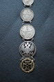 A 1915 COMMEMORATIVE CROSS & BONES WATCH FOB.