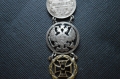 A 1915 COMMEMORATIVE CROSS & BONES WATCH FOB.