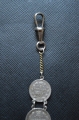 A 1915 COMMEMORATIVE CROSS & BONES WATCH FOB.