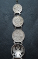 A 1915 COMMEMORATIVE CROSS & BONES WATCH FOB.