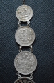 A 1915 COMMEMORATIVE CROSS & BONES WATCH FOB.