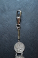 A 1915 COMMEMORATIVE CROSS & BONES WATCH FOB.