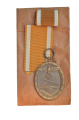 A West Wall Campaign Medal with ribbon and enwelope maker Karl Hensler, Pforzheim.