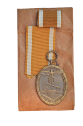 A West Wall Campaign Medal with ribbon and enwelope maker Karl Hensler, Pforzheim.