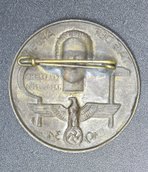 A 1934 National Day of Labour Badge maker marked.