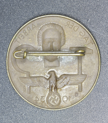 A 1934 National Day of Labour Badge maker marked.