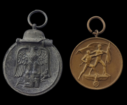 Two badges. Eastern Winter Campaign Medal and Commemorative Sudetenland Medal.