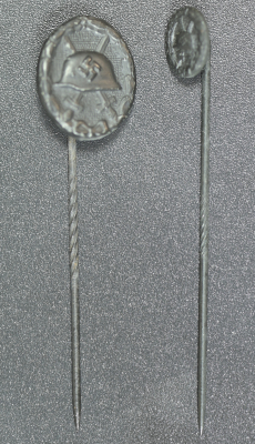 Set Wound Badge Black stickpins, one marked L/18 