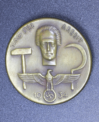 A 1934 National Day of Labour Badge maker marked.